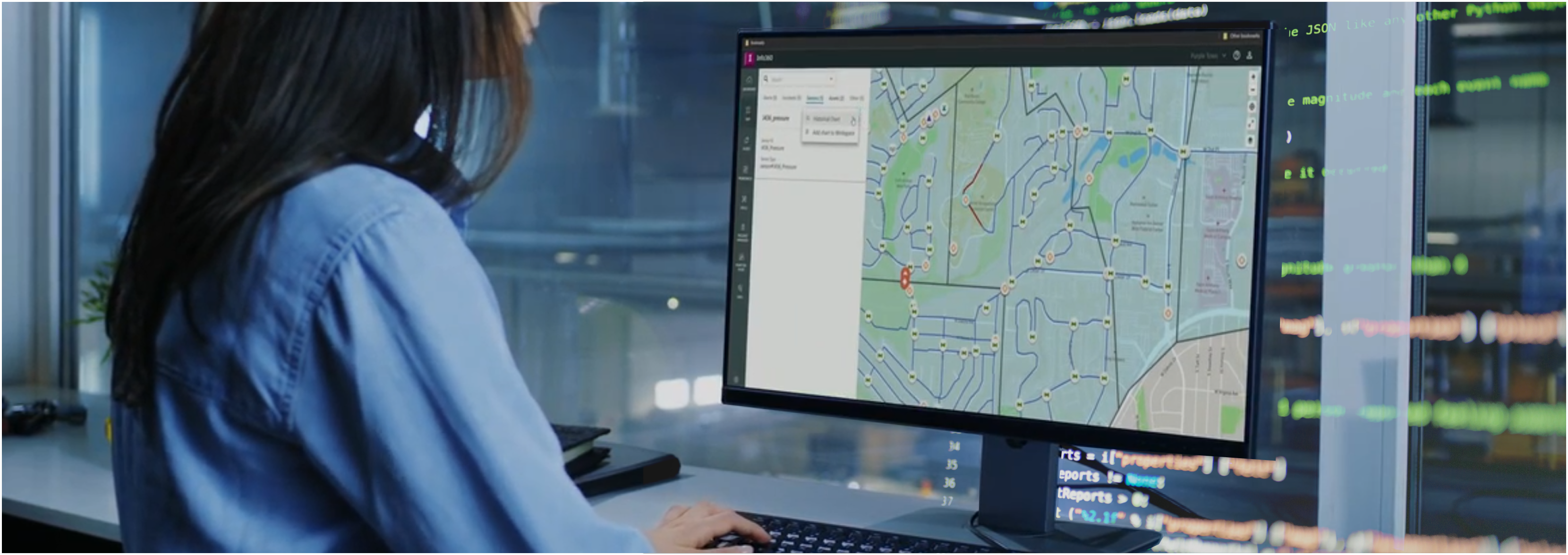 A woman working on Info360 with lines of code in the background.