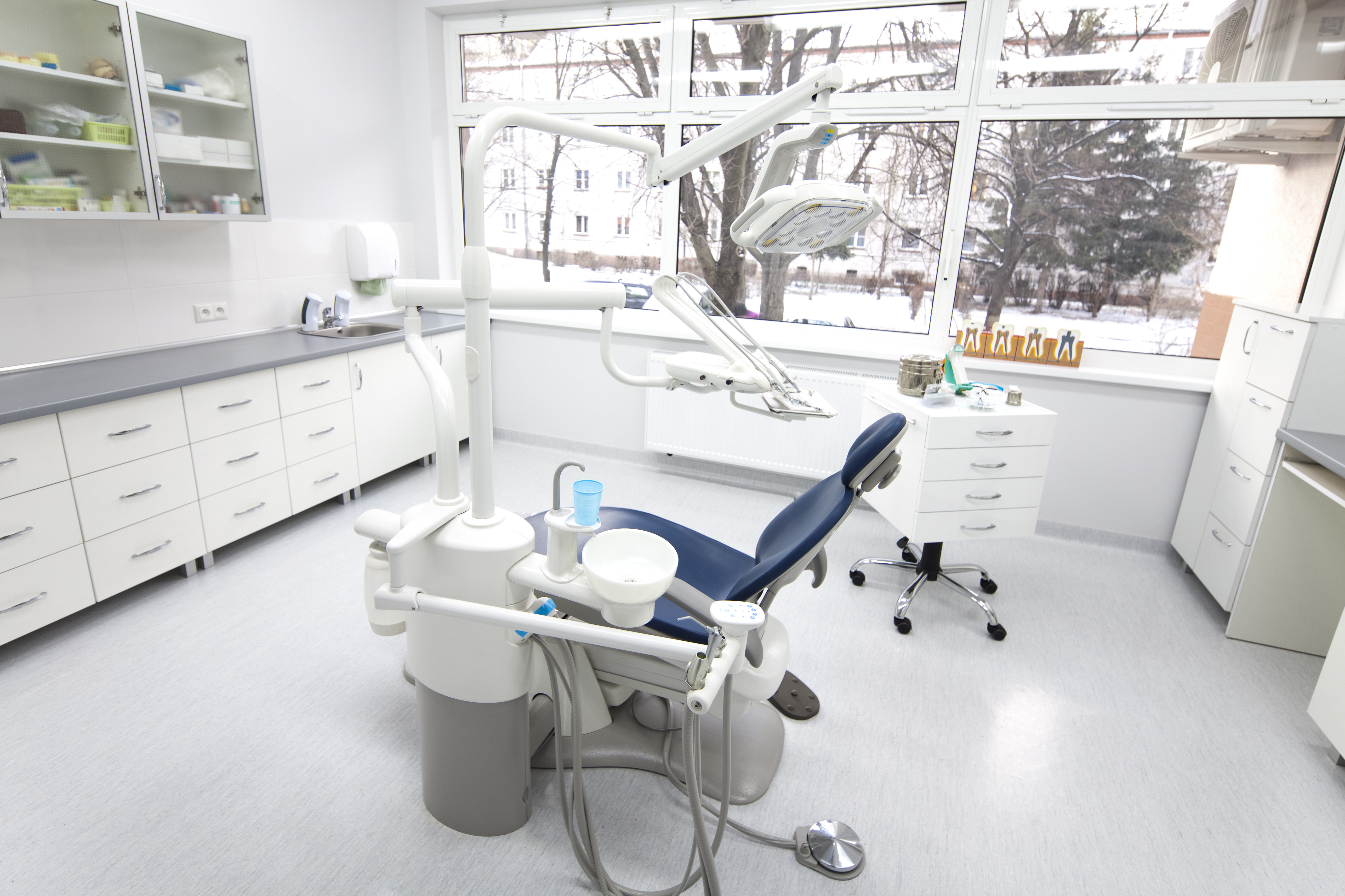 A dental chair in a white clinic during winter.